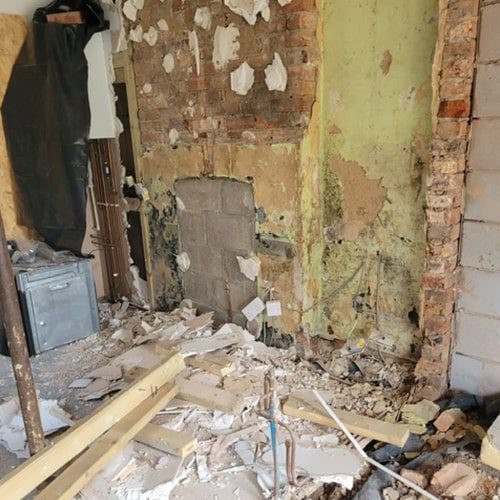 Removing the plaster back to brickwork